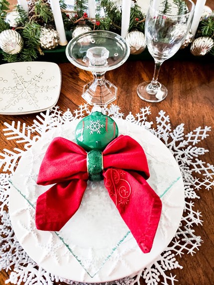 white plate with a red bow napkin