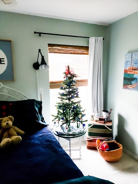 a dark bedroom with a Christmas tree in the window Guest Room Update