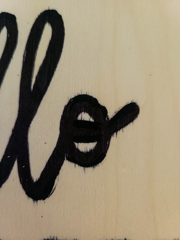 Showing the letters that bled onto the wood when using markers