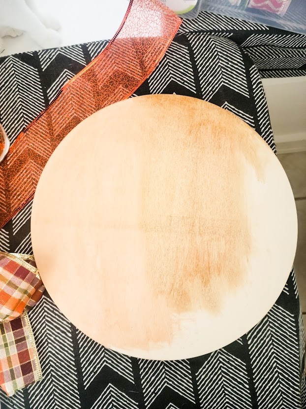 Wood disc showing different colors of stain