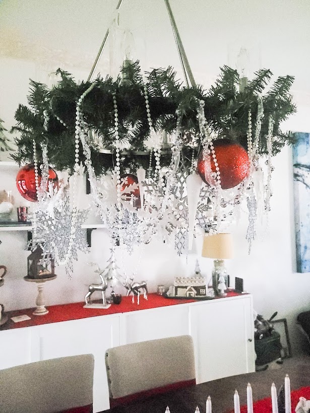 A picture of my finished Christmas chandelier with red ornaments added