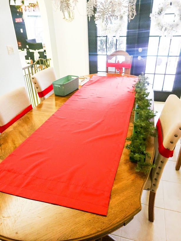 A picture of my red curtain panel turned into a dining room table runner.