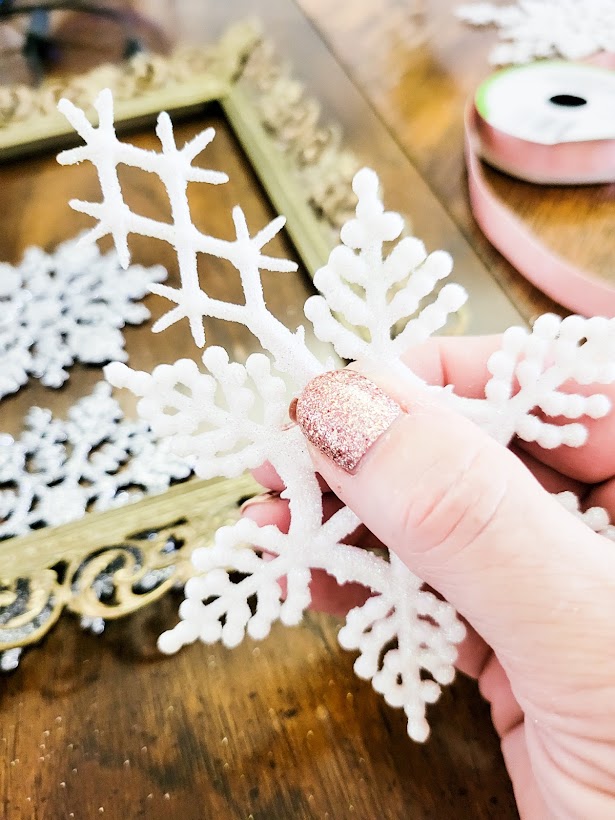 A picture of me snapping off the longer legs of this snowflake to make it into a smaller snowflake