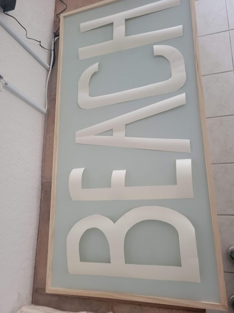 A picture my beach sign with the lettering cut out and sitting on the top of the sign