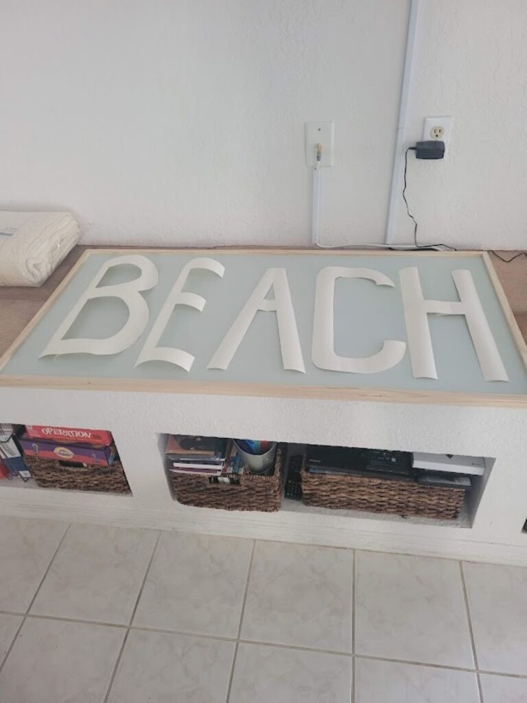 A picture my beach sign from a different angle with the lettering cut out and sitting on the top of the sign