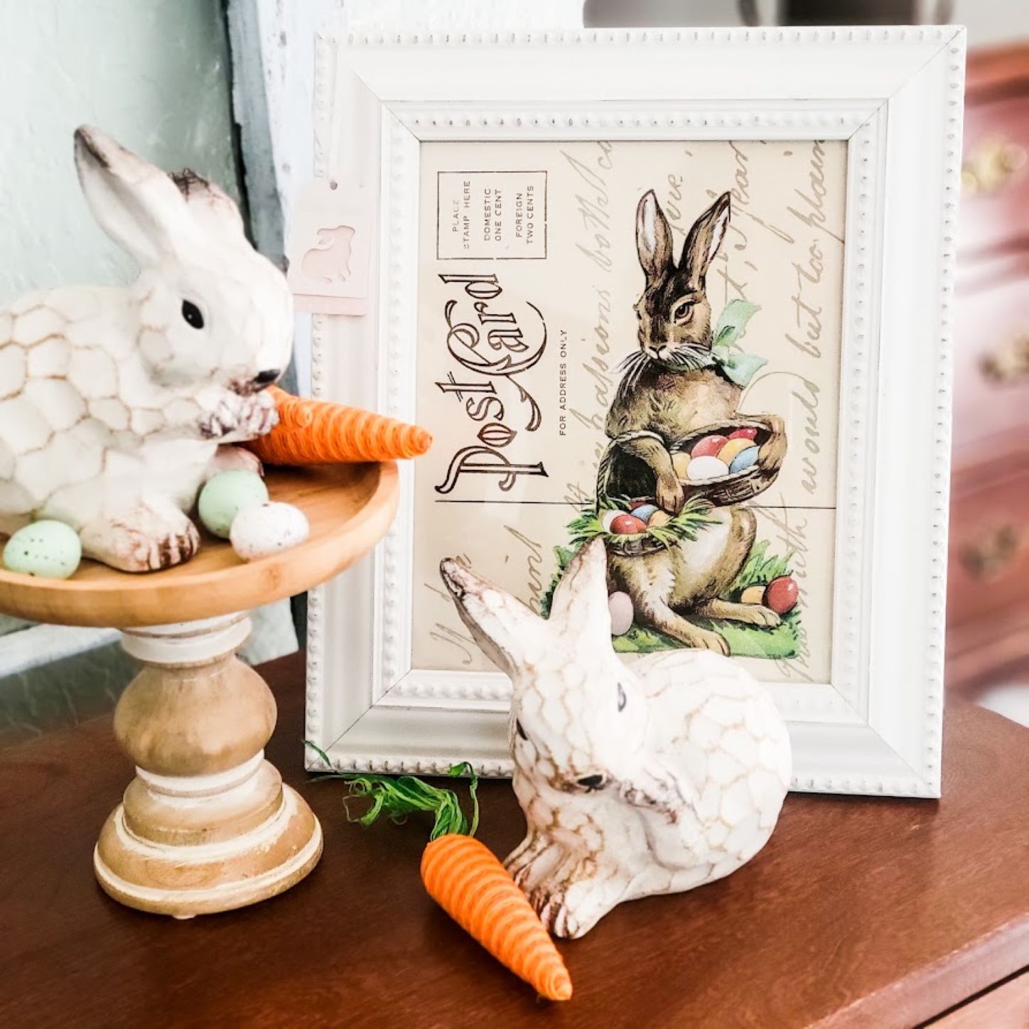 A framed picture of a rabbit postcard and a statue of two rabbits on a table how-to-make-Printable-Easter-Rabbit-Postcard-Framed