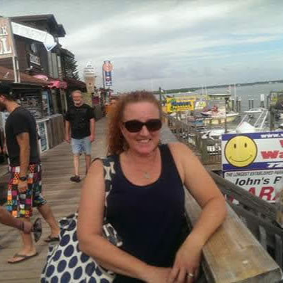 woman with a polka dot bag on a pier