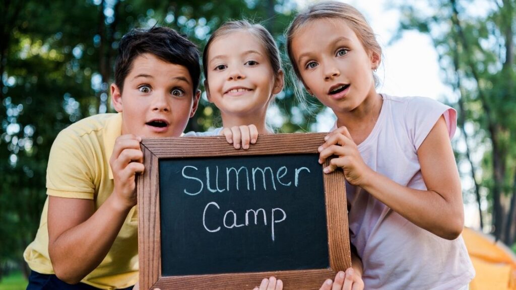 children with a summer camp sign