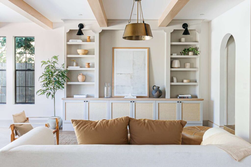 white living room with floor to ceiling book shelves