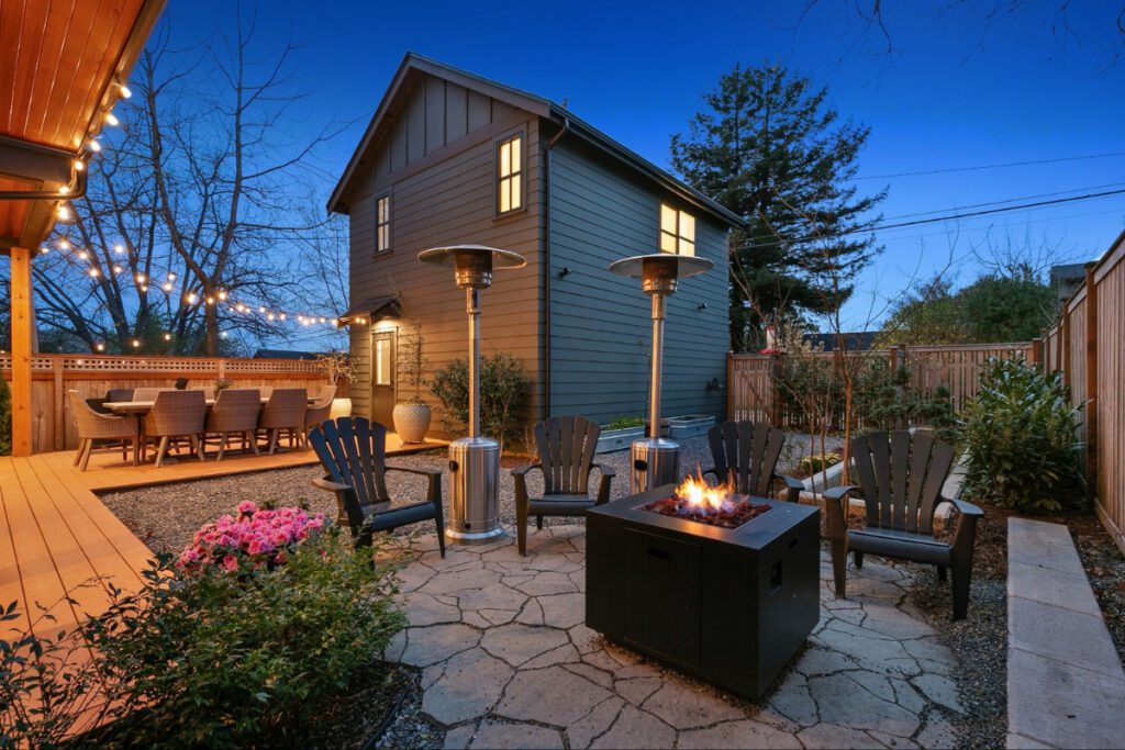 backyard at night with firepit and outdoor heaters