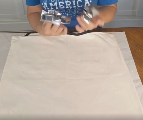 preparing a white pillow cover to be painted