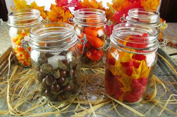 canning jars with fall inspired fillers and a votive candle