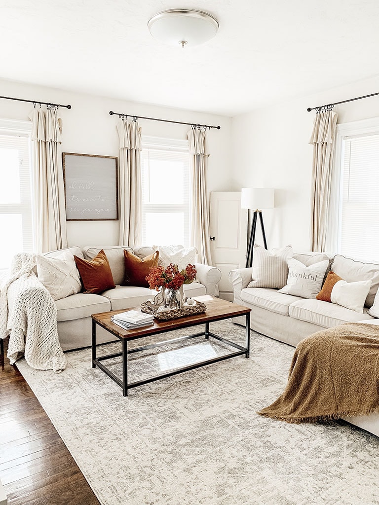 white living room with rust-colored pillows