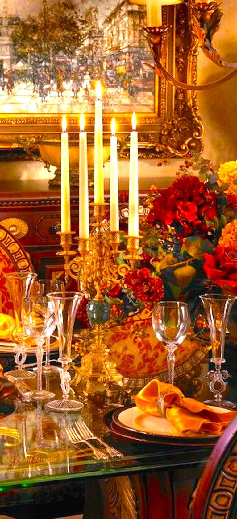 orange and red tablescape at night with lit candelabra