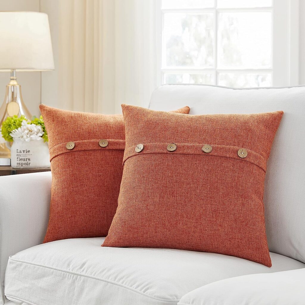 white sofa with orange pillows