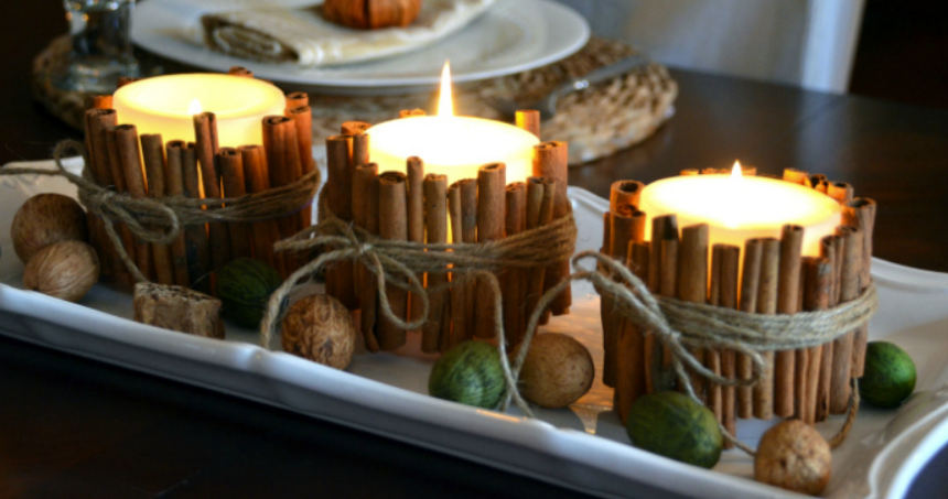 white candles wrapped with cinnamon sticks