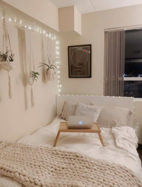 all white dorm room with string lights