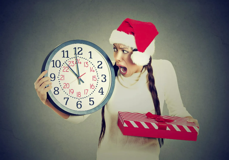 a person holding a clock and a Christmas present