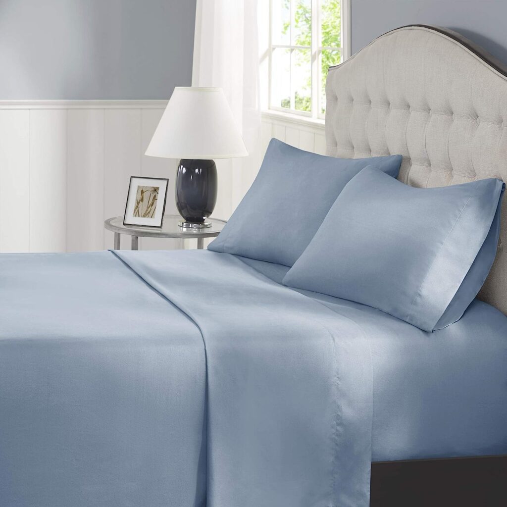bedroom with white headboard and blue sheets