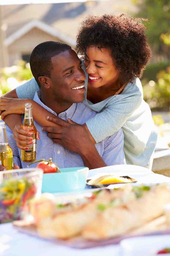 man and woman laughing at a picnic