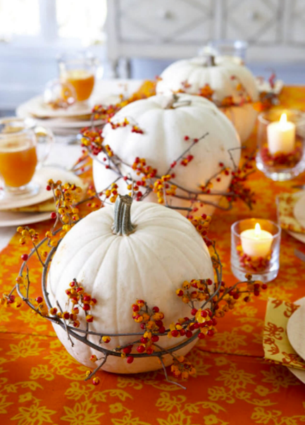 white pumpkins wrapped with bittersweet vines as a tablescape