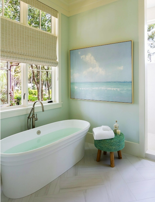bath tub with beach painting and large window