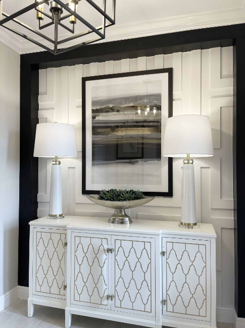 black and white entryway with buffet and 2 lamps