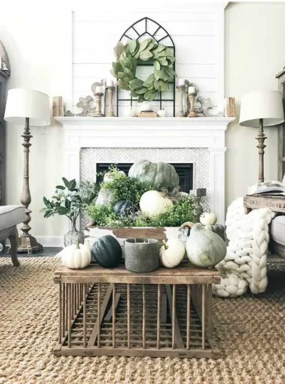 white living room with fireplace with sage green fall decor