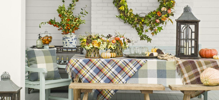 picnic table with plaid tablecloths and fall-inspired centerpiece