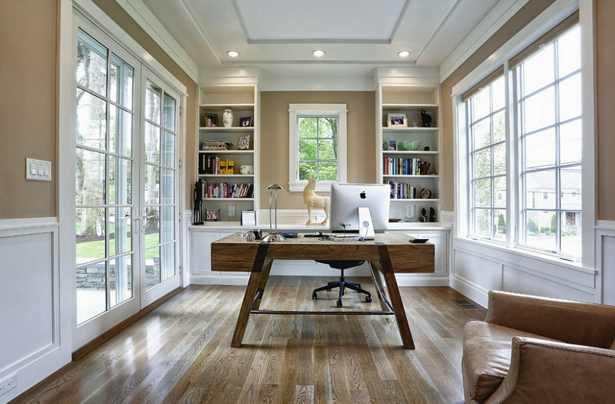 home office with large windows and bookshelves