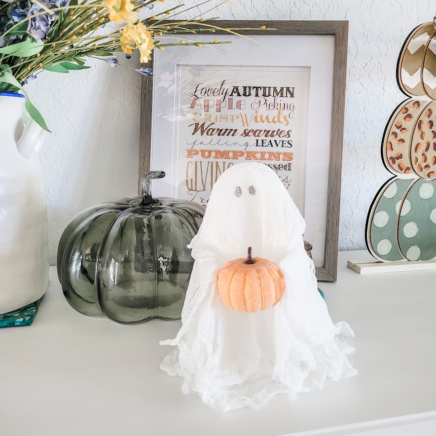 halloween cheesecloth ghost holding a tiny pumpkin