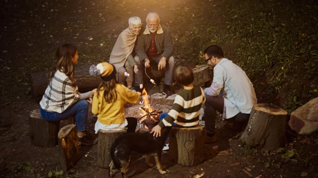 family around a bonfire roasting marshmallows