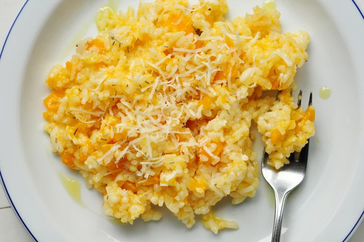 butternut squash risotto on a plate with a fork