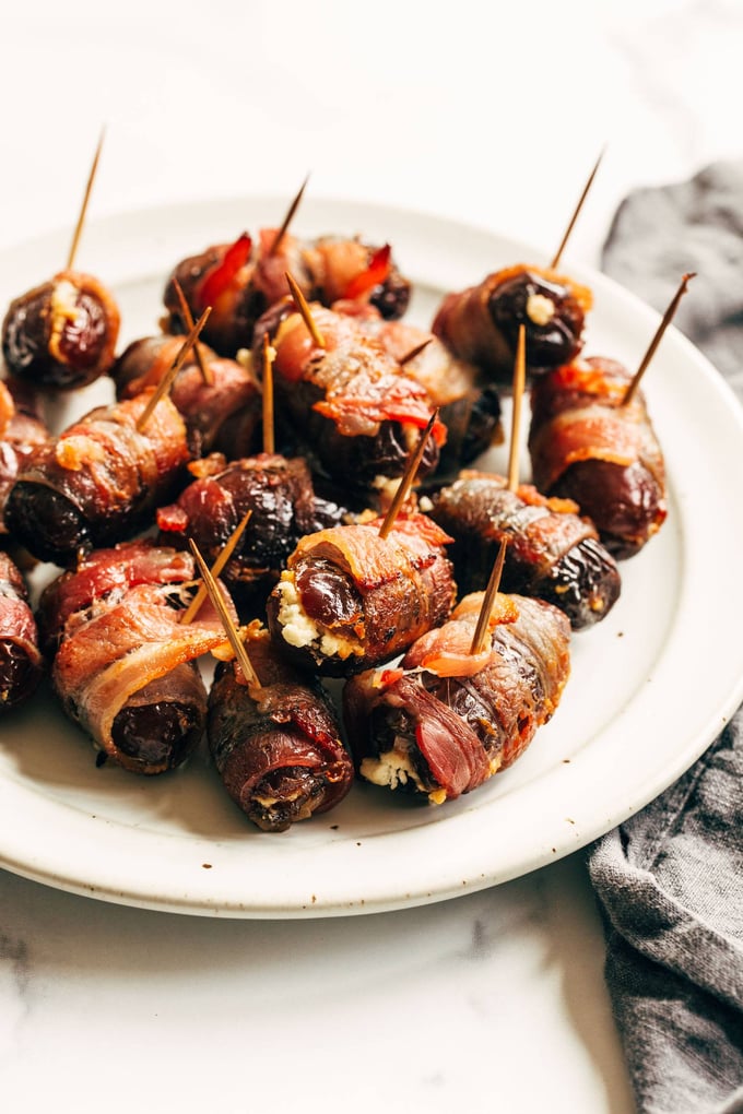 a white plate of bacon wrapped dates