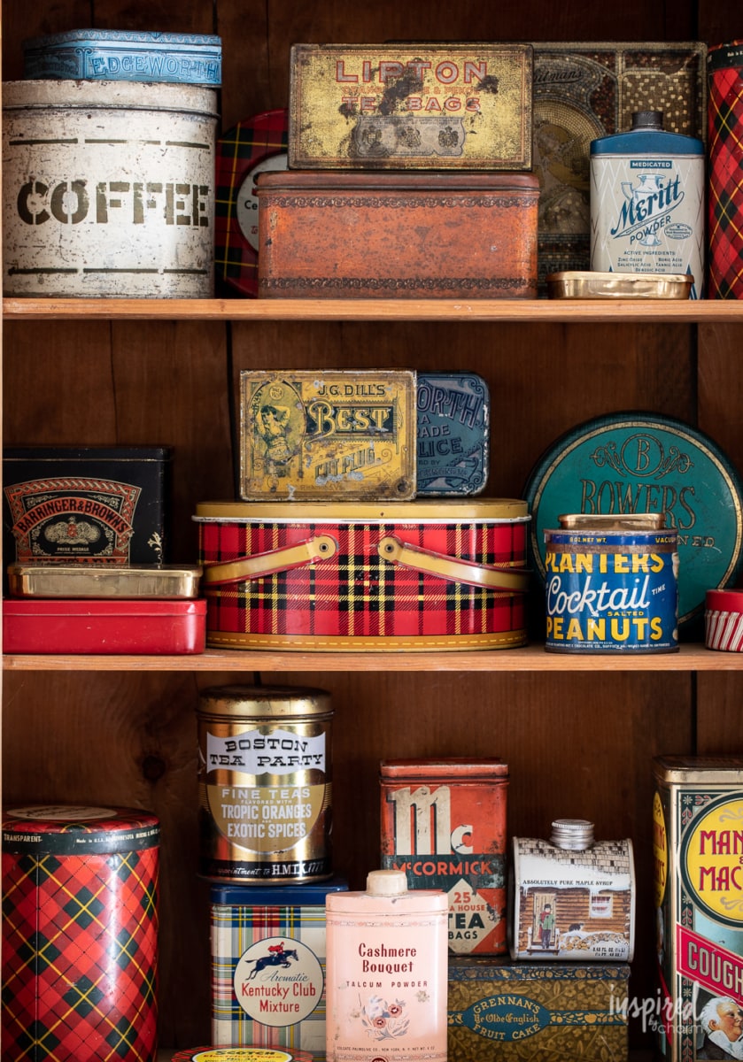 a collection of vintage tins on a shelf