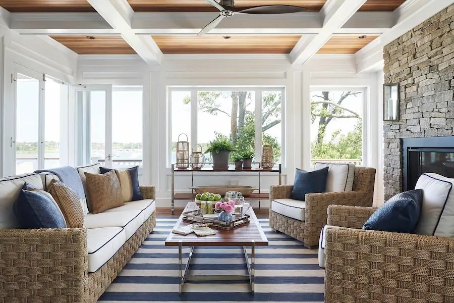 white living room with blue and white striped rug and large windows