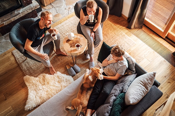 family sitting in living room talking home as a living, breathing entity