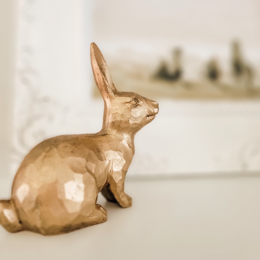 seated gold bunny with framed art