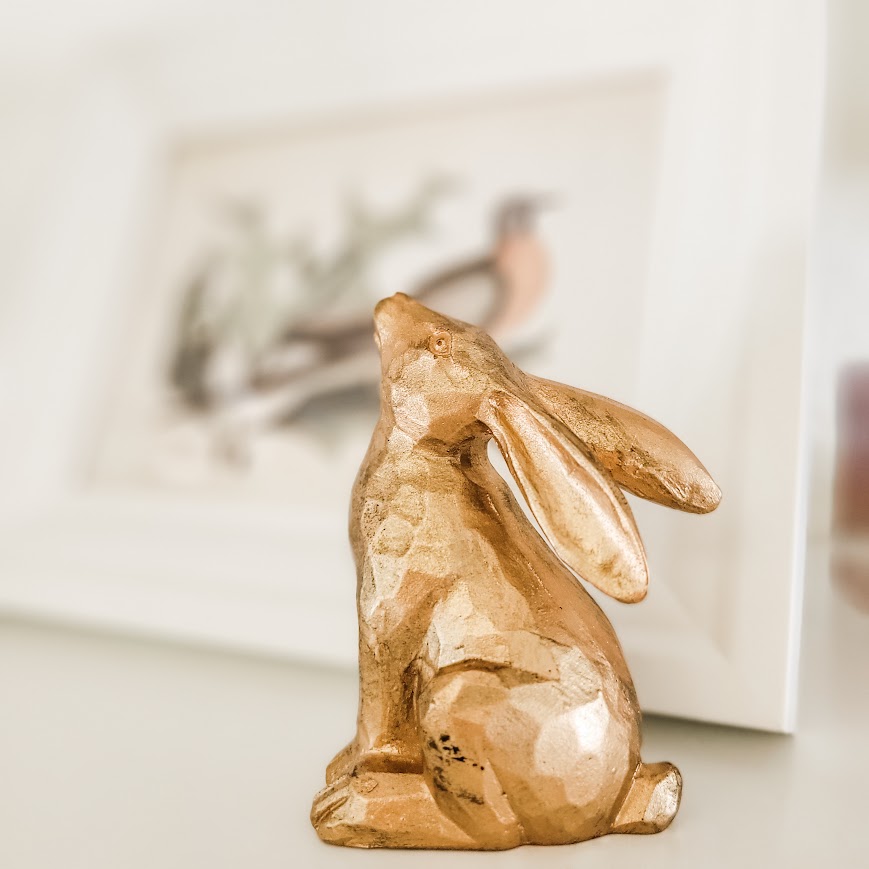 seated gold bunny with framed art