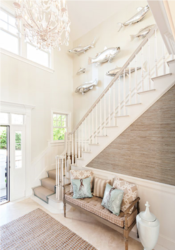 Entryway with silver fish sculptures on the wall coastal decor ideas for a beach-inspired look