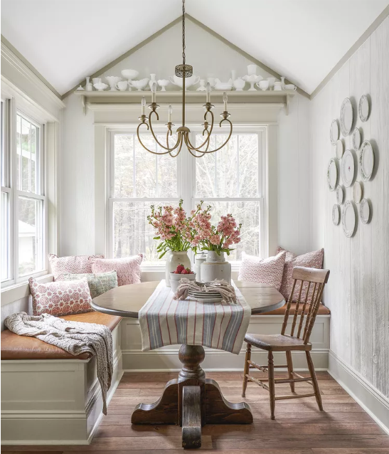 white breakfast nook with pillows and a table runner cottagecore home decor