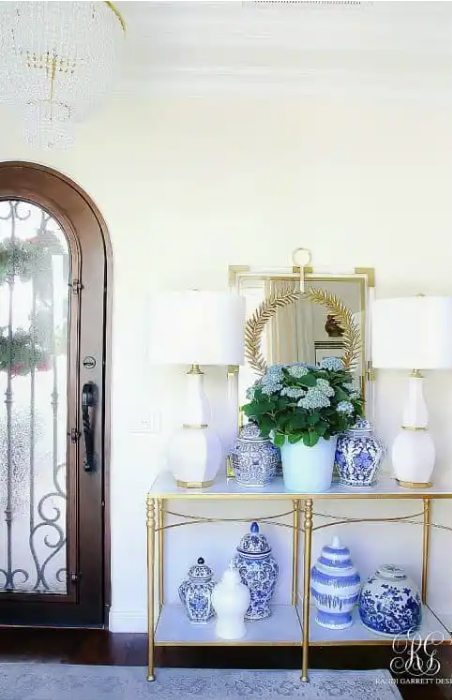 entryway with chinoiserie vases and an arched doorway Grandmillenial home decor