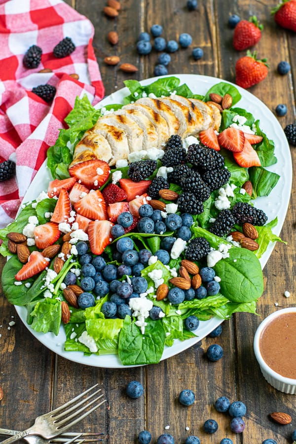 a plate of summer berry salad with grilled chicken