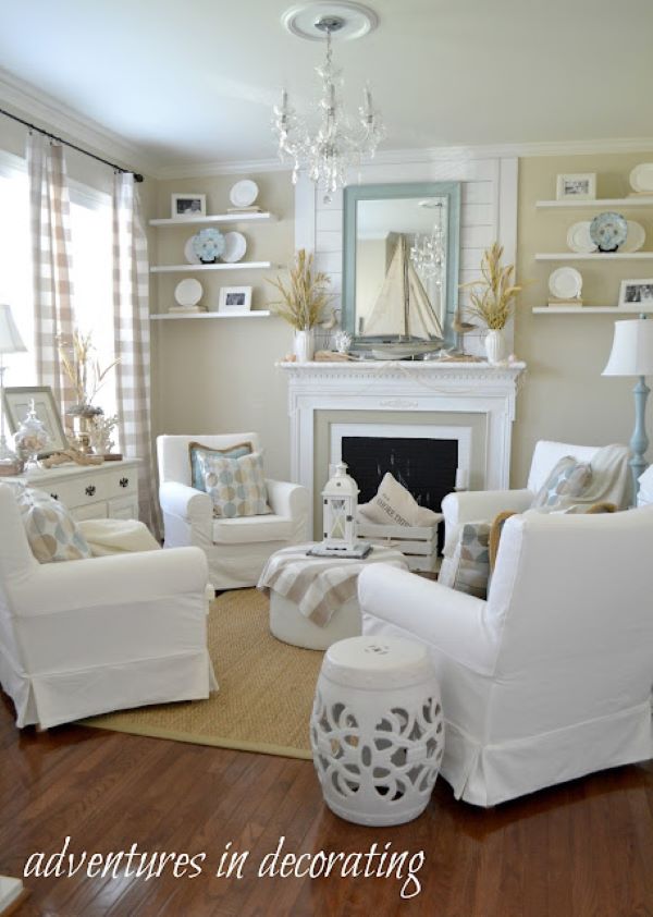 white living room with a fireplace decorated with a sailboat fireplace mantel summer decor