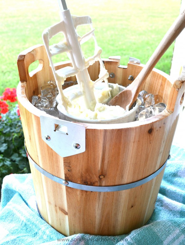 a wooden ice cream maker outside with vanilla ice cream inside