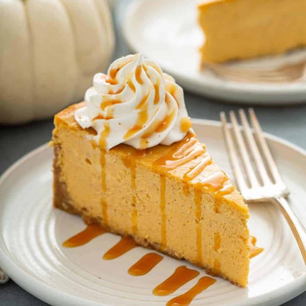 plated pumpkin cheesecake with carmen sauce drizzled on top