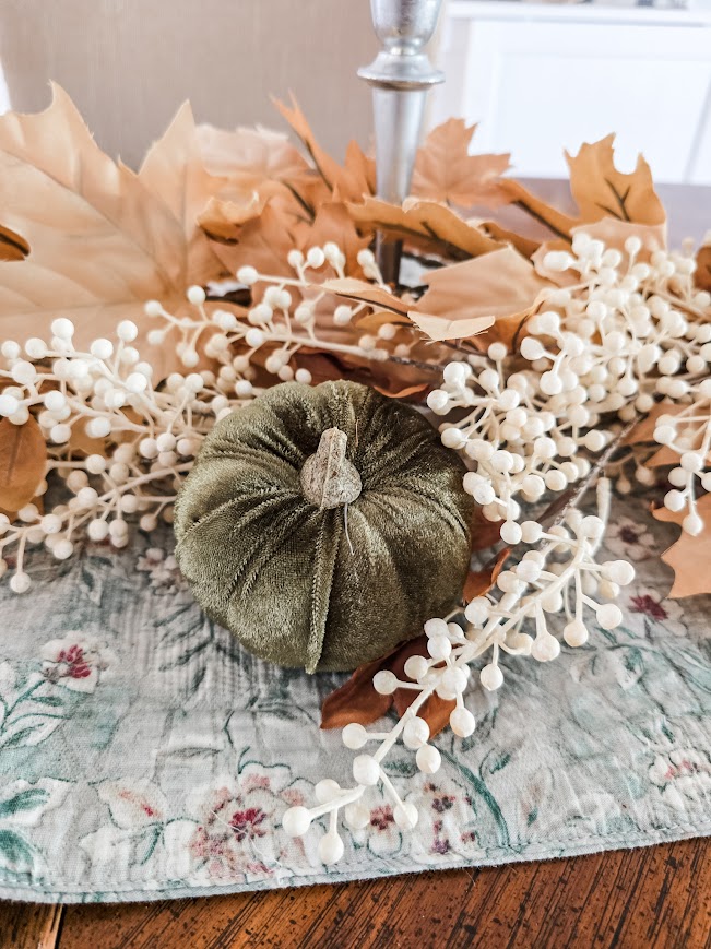 fall florals and a small green velvet pumpkin on a table crafting the perfect tablescape