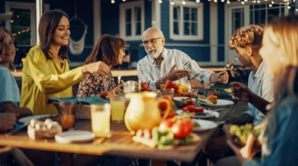 adults laughing at the dinner table great conversation starters for your next party