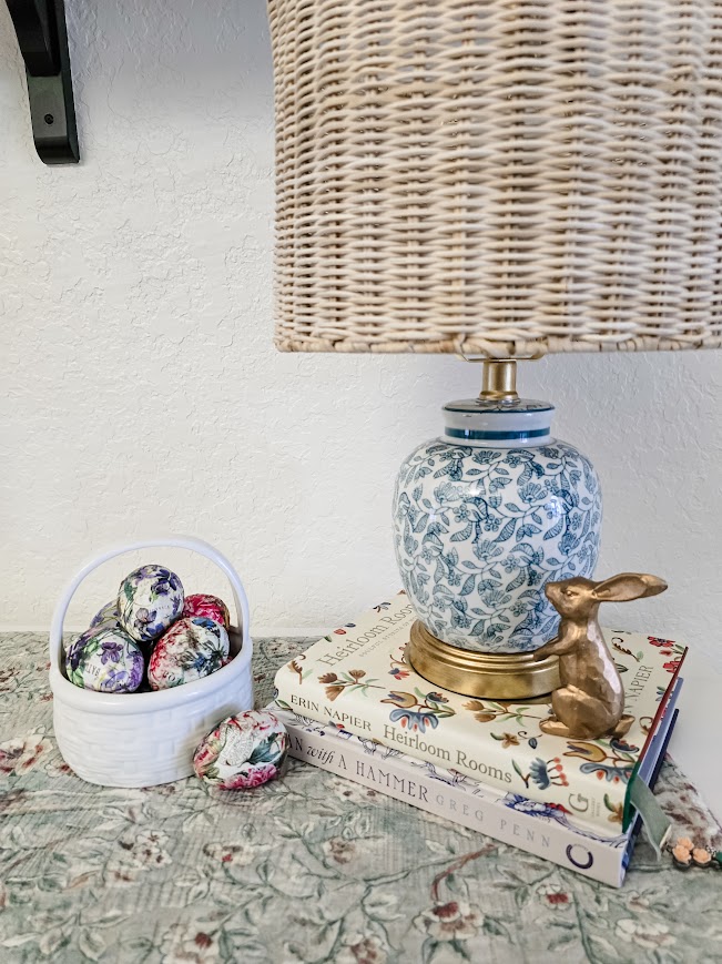 finished Easter vignette with a lamp, bunny, and ceramic Easter basket with paper mache eggs transform any flat surface with designer flair