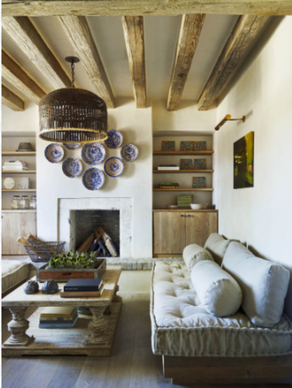 white living room with beams on the ceiling and a large basket chandelier determine your decorating style quiz